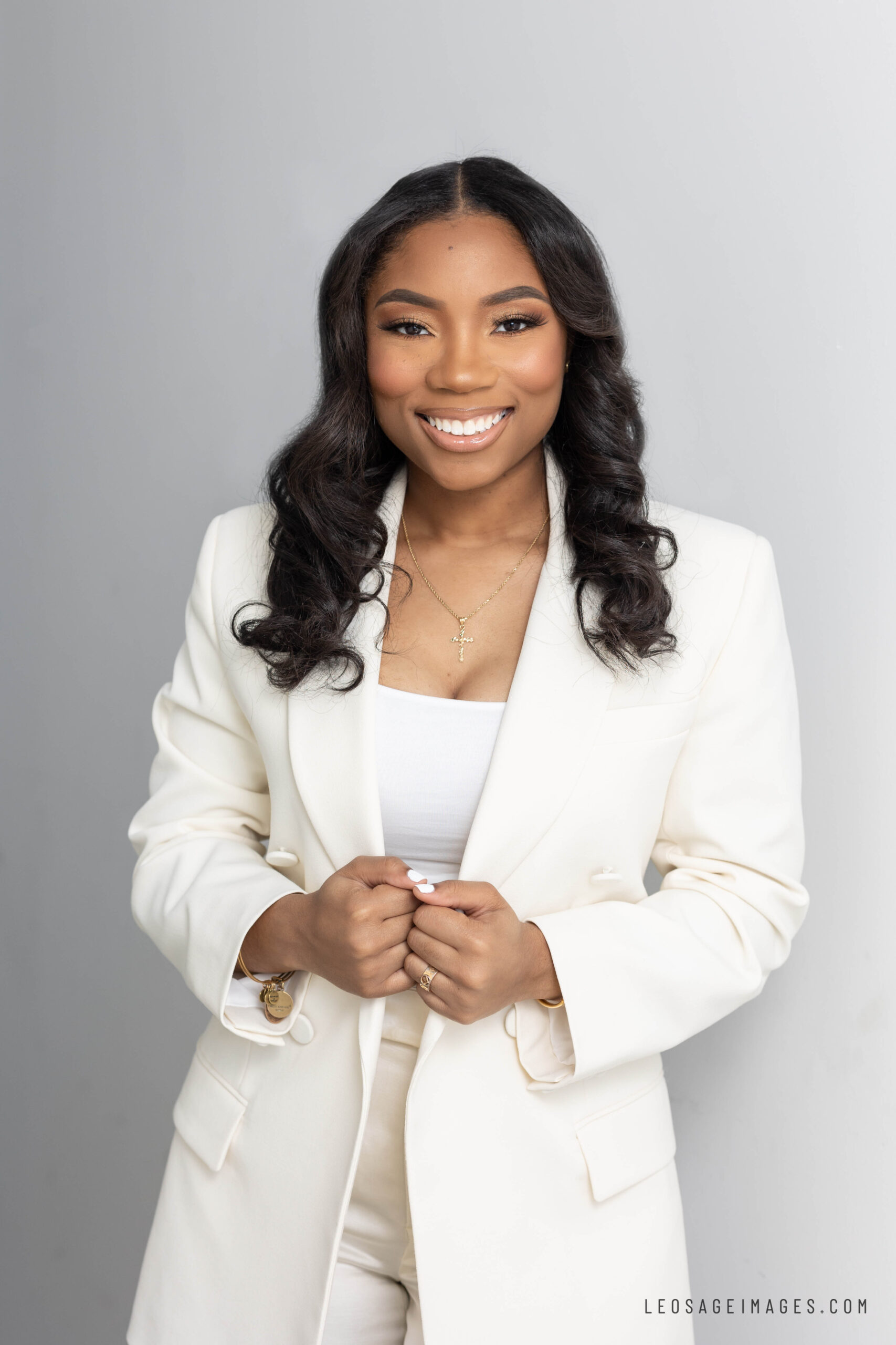 professional business headshot of a black woman in cream suit